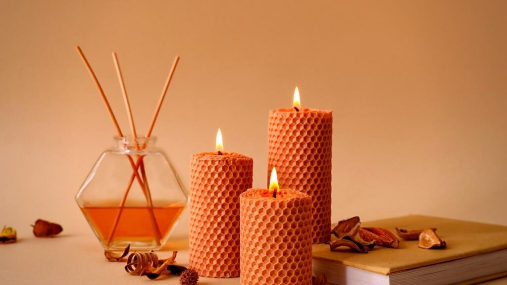 autumn reed diffuser beside honeycomb candles