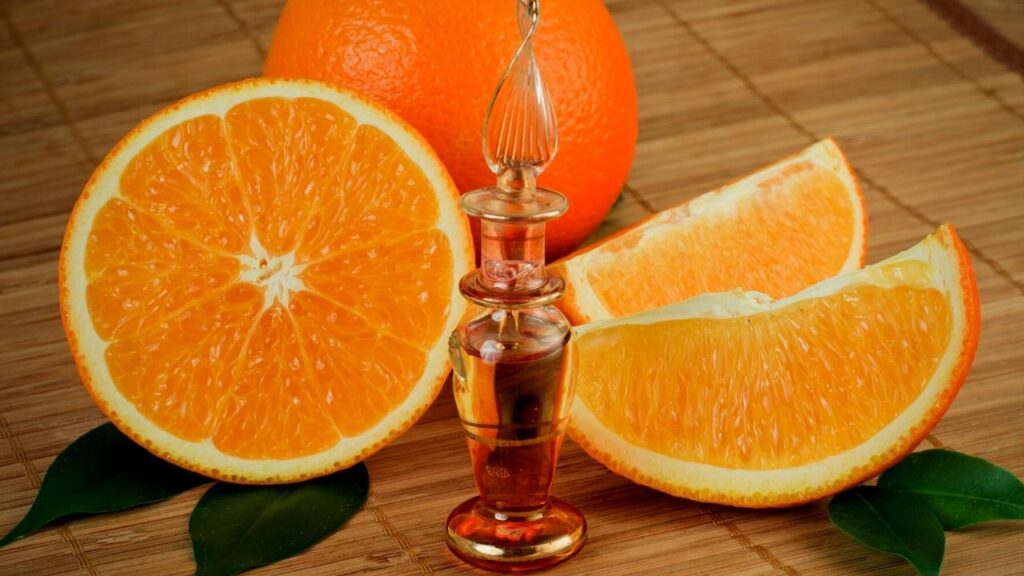 bottle of oils beside orange slices