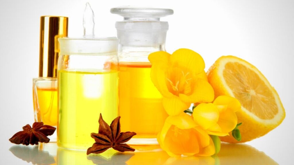 bottles of natural oils with yellow flowers and lemon