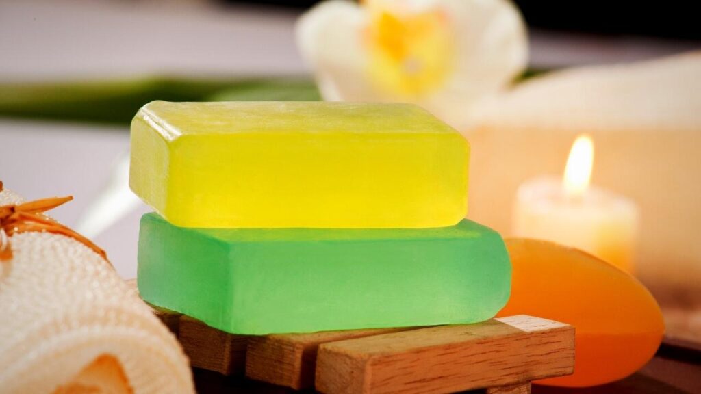 green and yellow soap bars beside candle