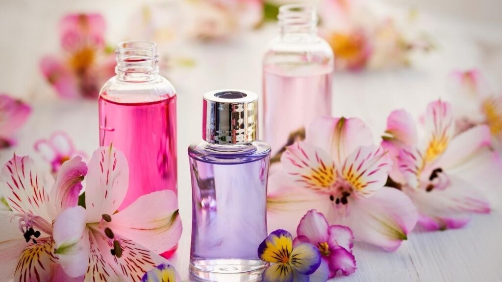 bottles of essential oils with pink flowers