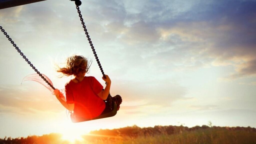 girl on swing in sunlight