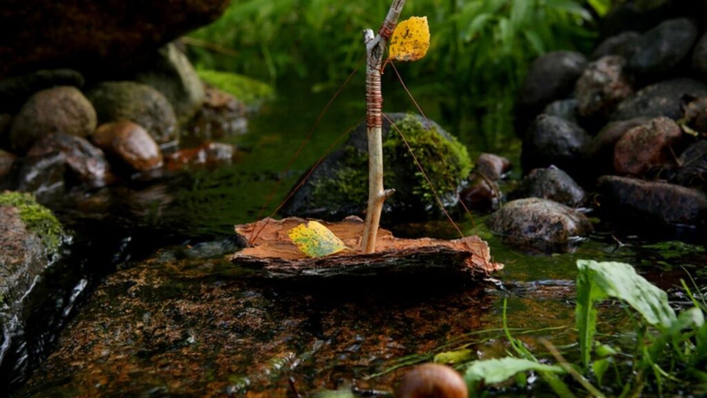 small homemade toy boat in water