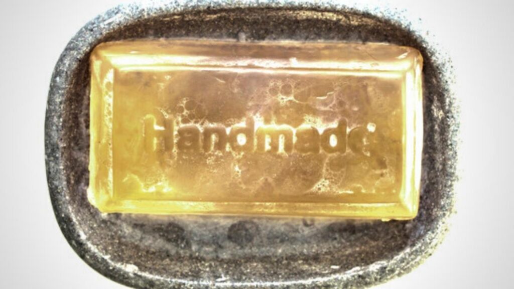 bar of olive oil soap with word "handmade" carved on top