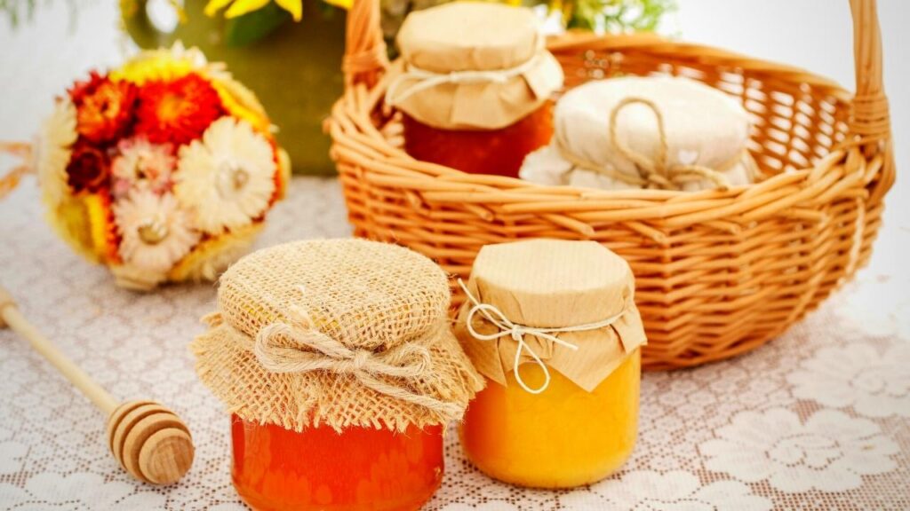 jars of honey on table and in basket