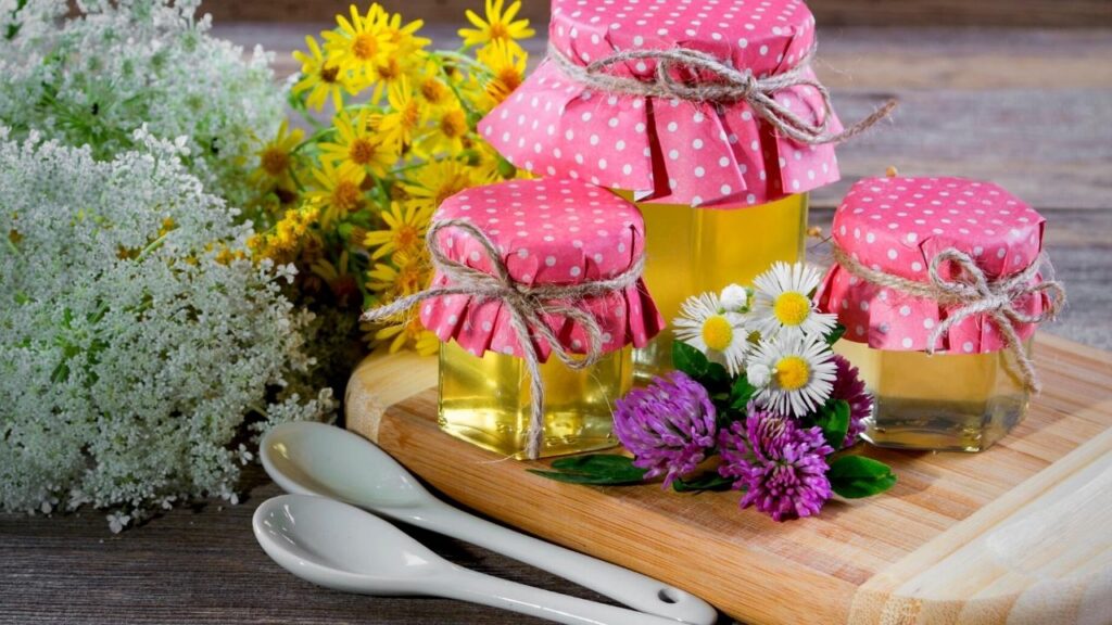 jars of honey with pink lids and flowers