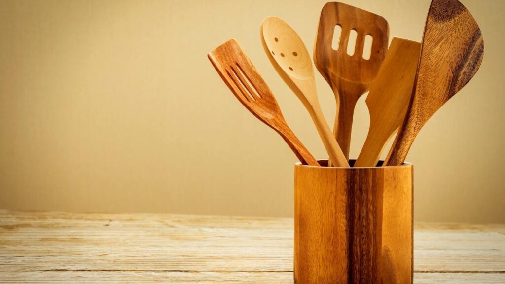 wooden kitchen utensils in a wood holder