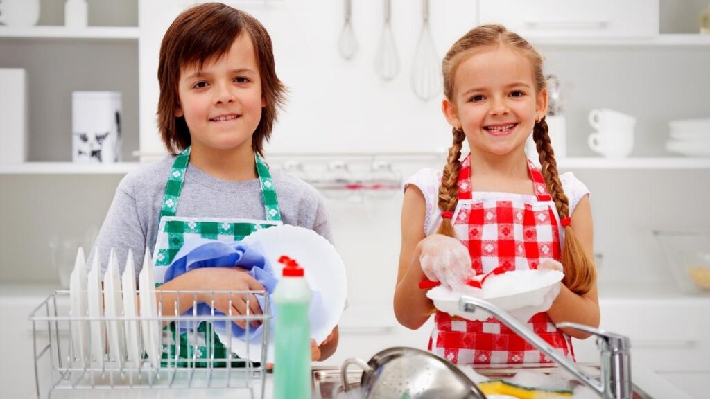 happy boy and girl washing dishes