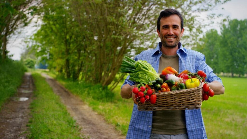 smiling farmer with basket of produce
