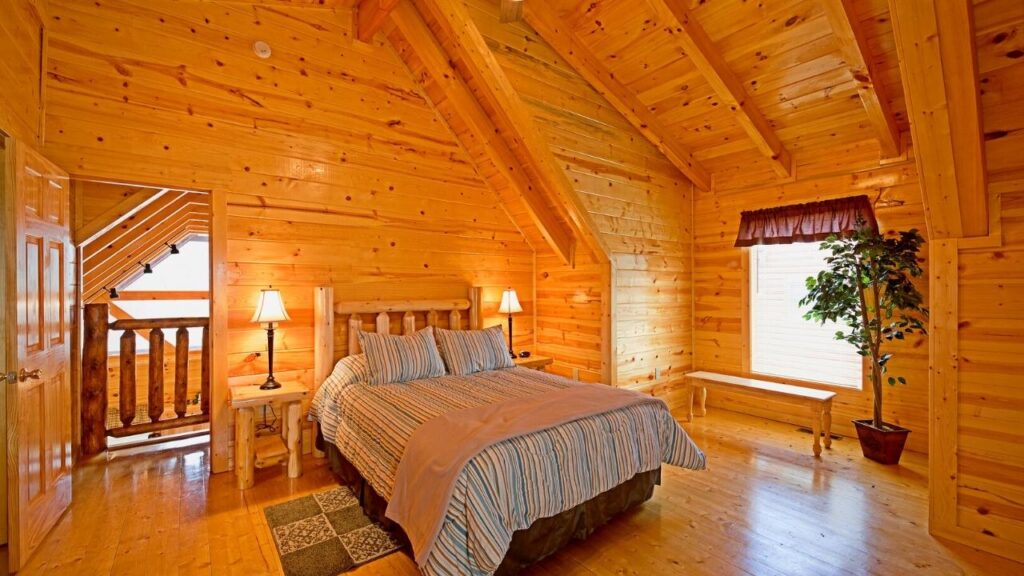 bedroom with wooden walls and floorboards