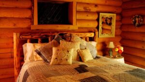 log cabin bedroom with patchwork quilt on bed