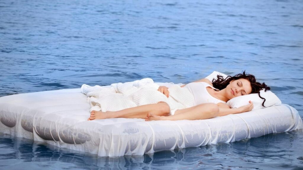 woman asleep on a bed floating on sea