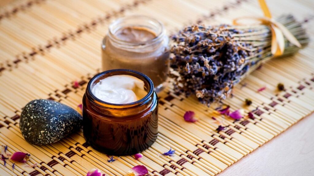 jar of lavender cream beside lavender sprigs