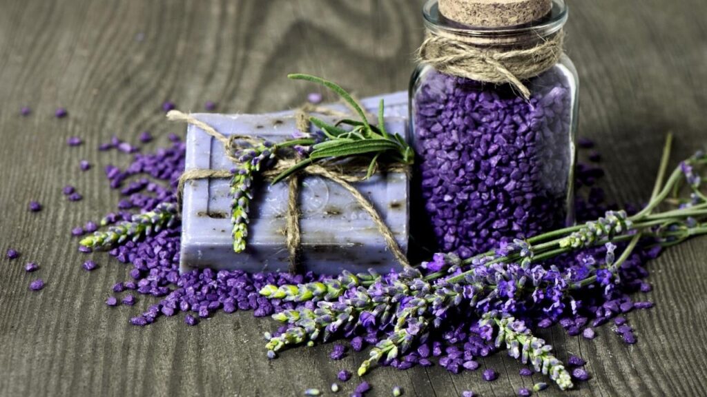 bottle of lavender salts, soap and lavender sprigs