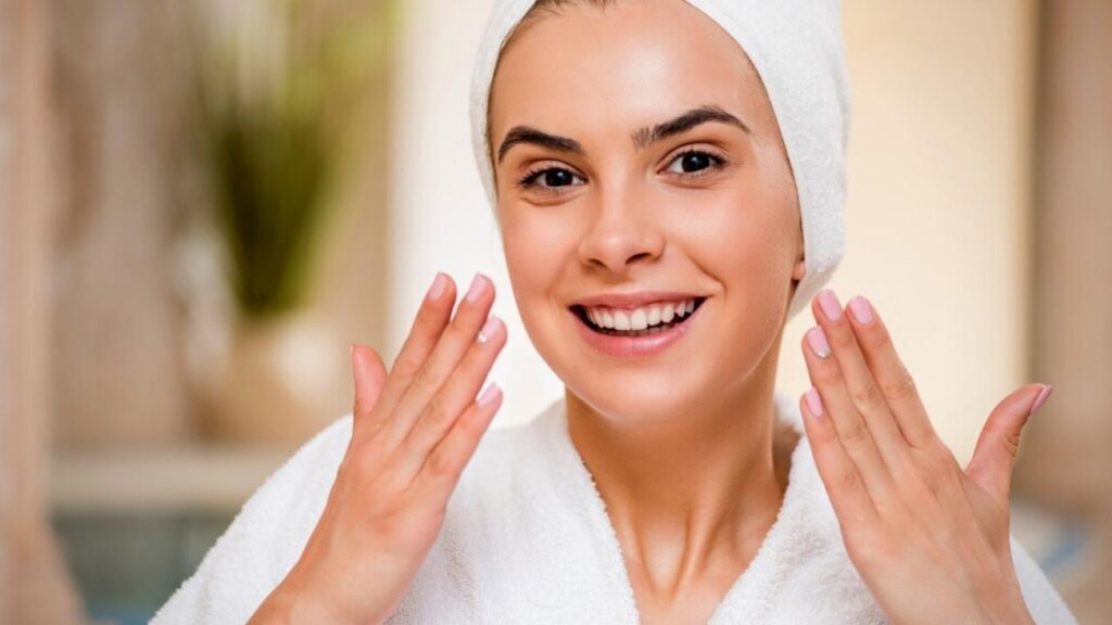 woman wearing white turban and gown washing face