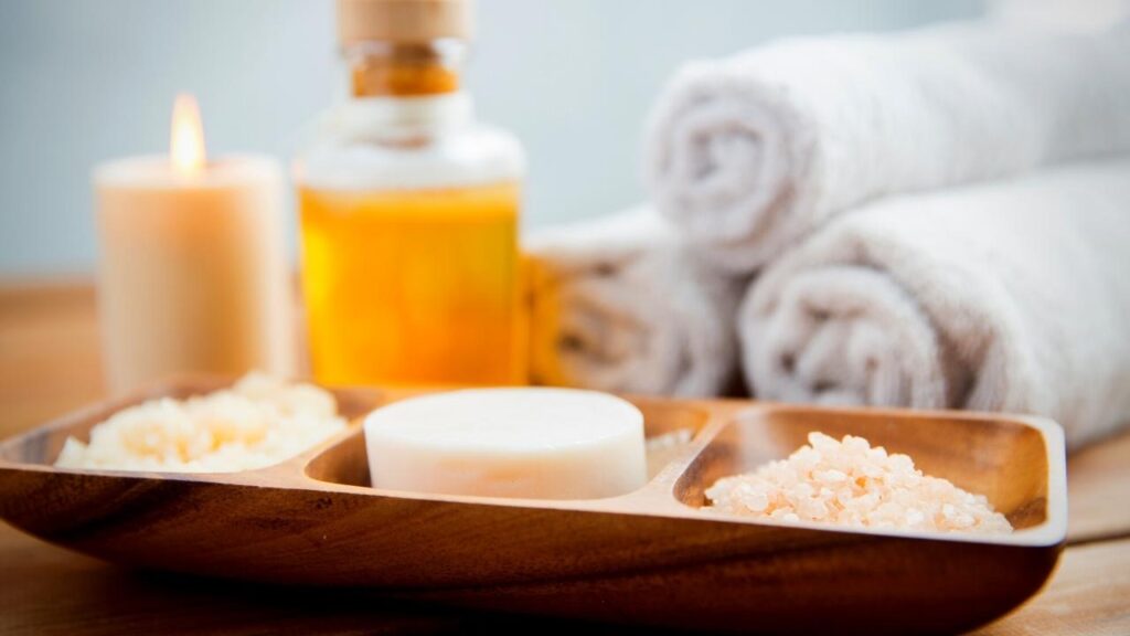 towels, oils, candles and sea salt beside bath