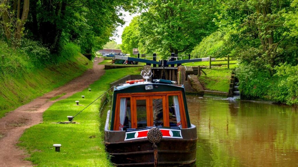 canal boat moored beside riverbank