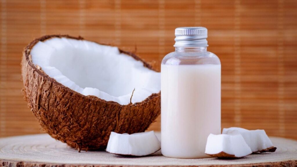 half a coconut and bottle of coconut shampoo
