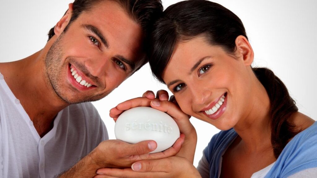 happy couple holding bar of healthy soap