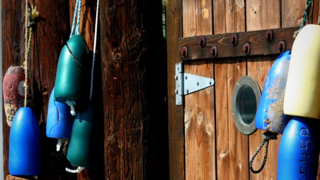 fishing floats strung together over wooden door