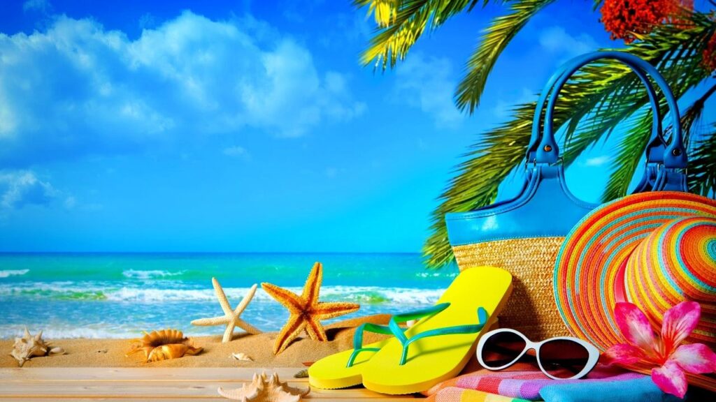 starfish, flip-flops, sunglasses, bag and straw hat on beach