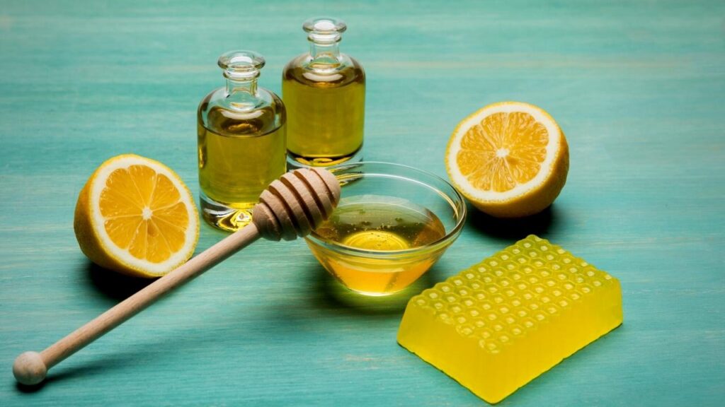 bottles of lemon, lemon halves and lemon soap