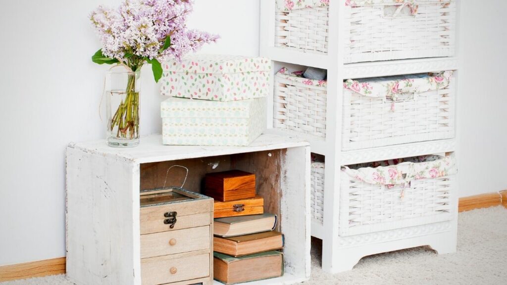 white and floral storage baskets beside white box table