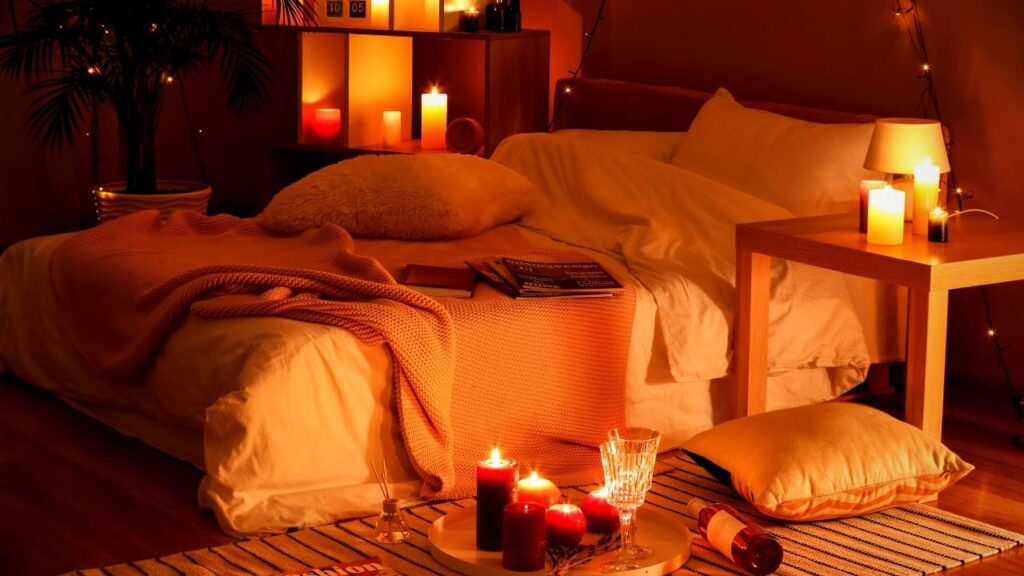 cosy bedroom lit with candles and fairy lights
