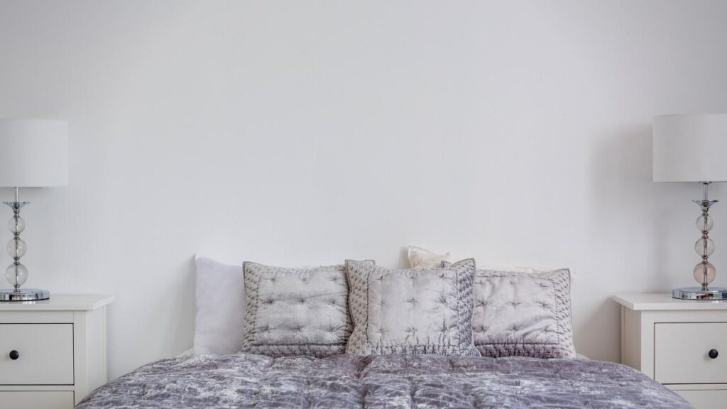 neutral coloured bedroom with grey pillows and duvet