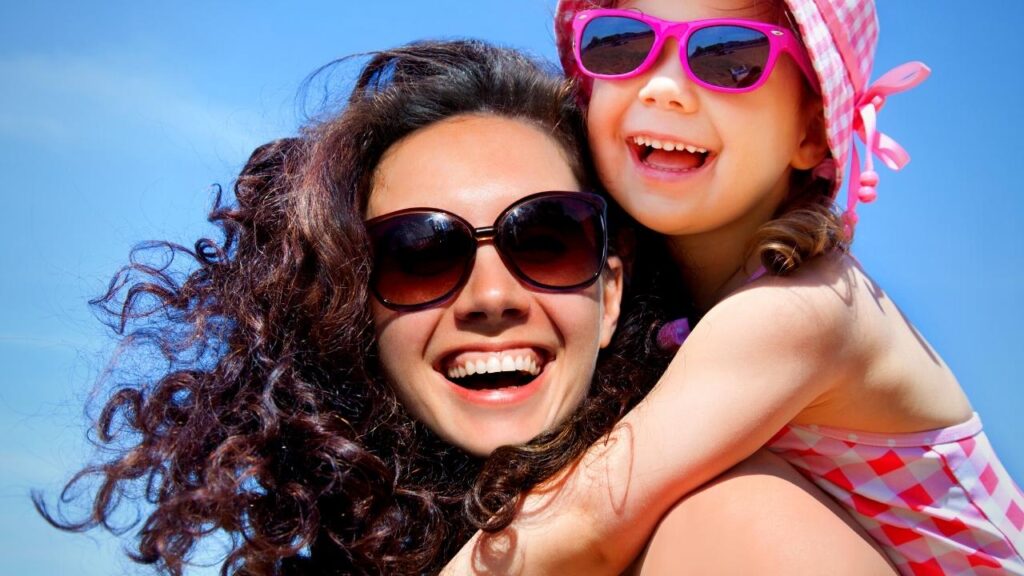 mother carrying daughter on back