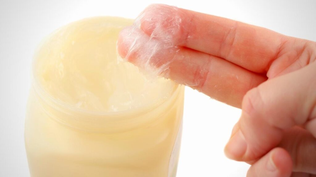 dipping two fingers in vaseline jar