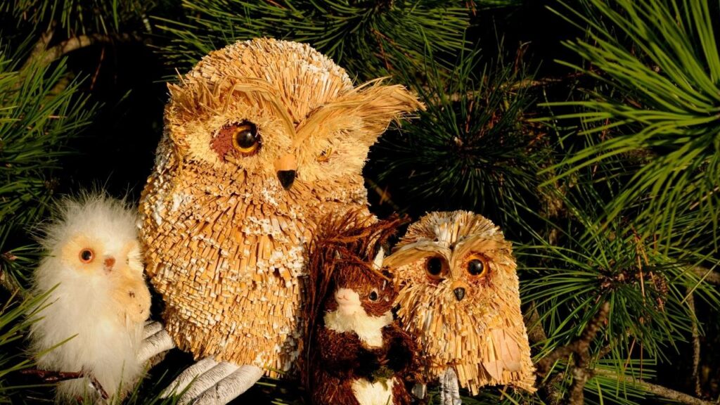 owls and squirrel decorating Christmas tree