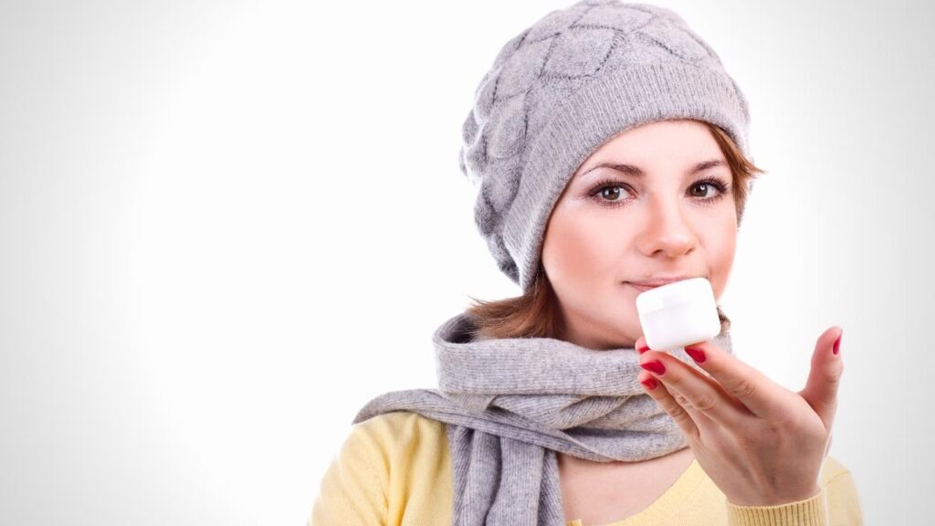 woman holding jar of hand cream