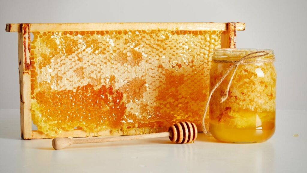 beeswax in frame with jar of honey
