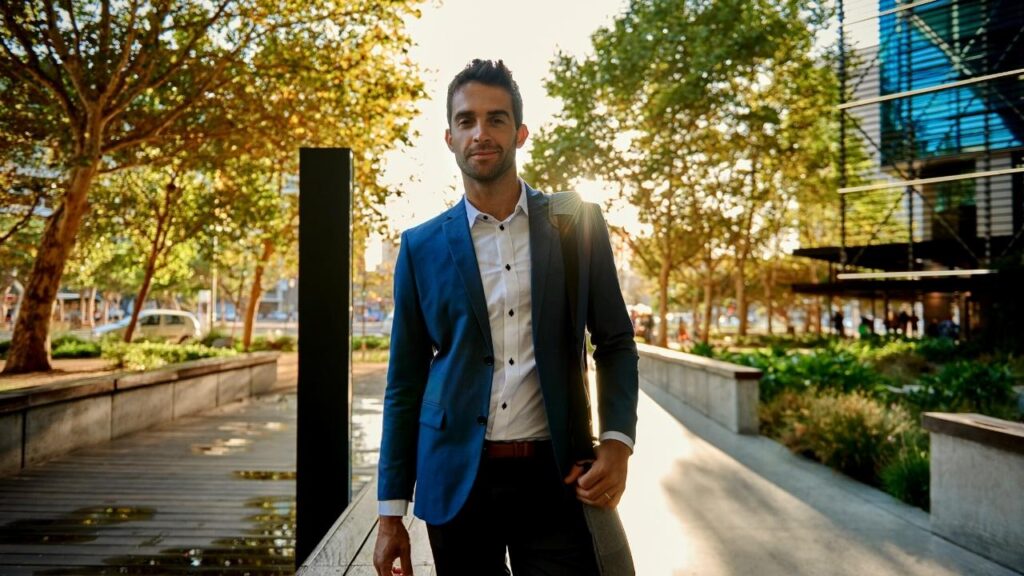 young man in suit with trees background