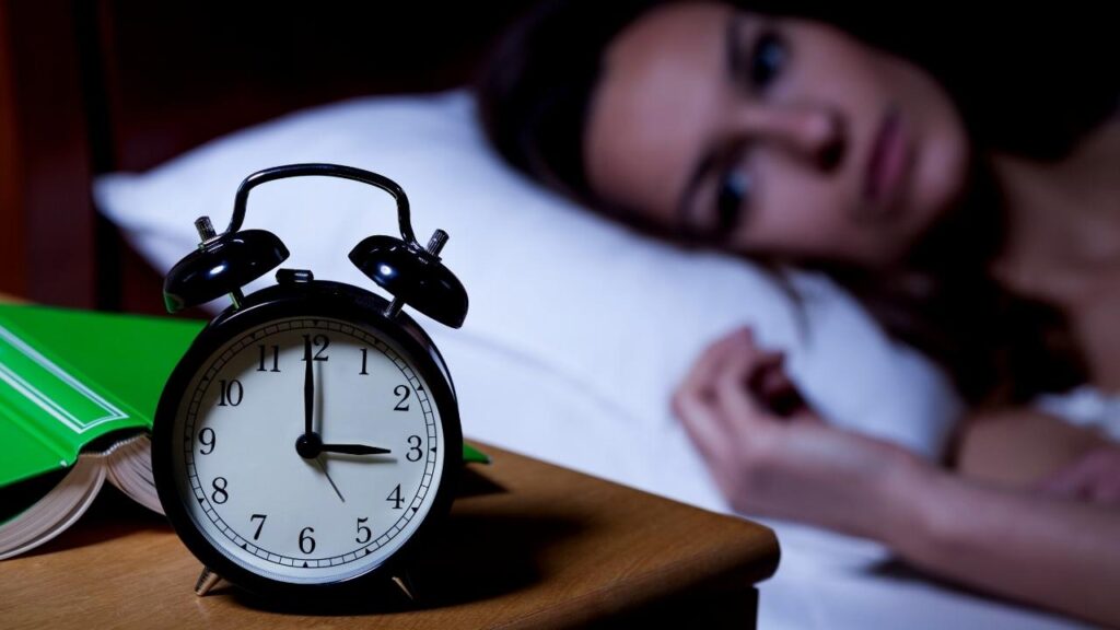 woman looking at clock at 3am
