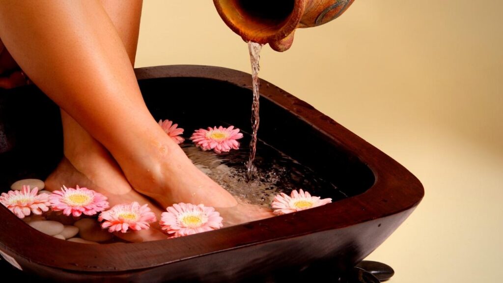 woman pouring water into foot basin