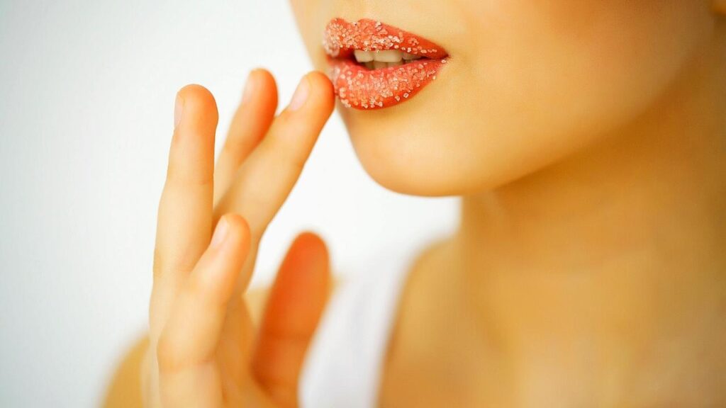 woman applying lip scrub