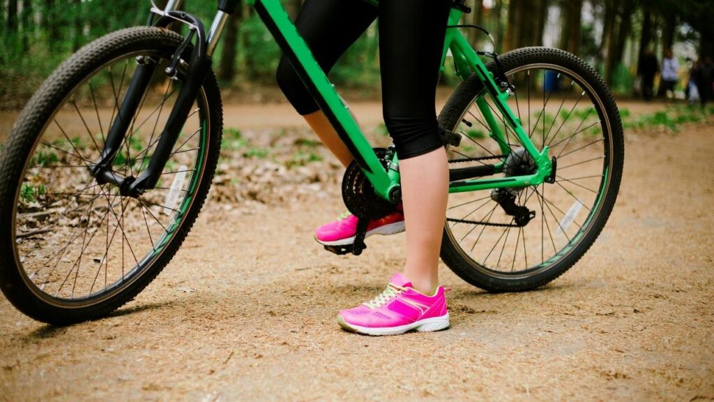 view of womans legs while on green bike