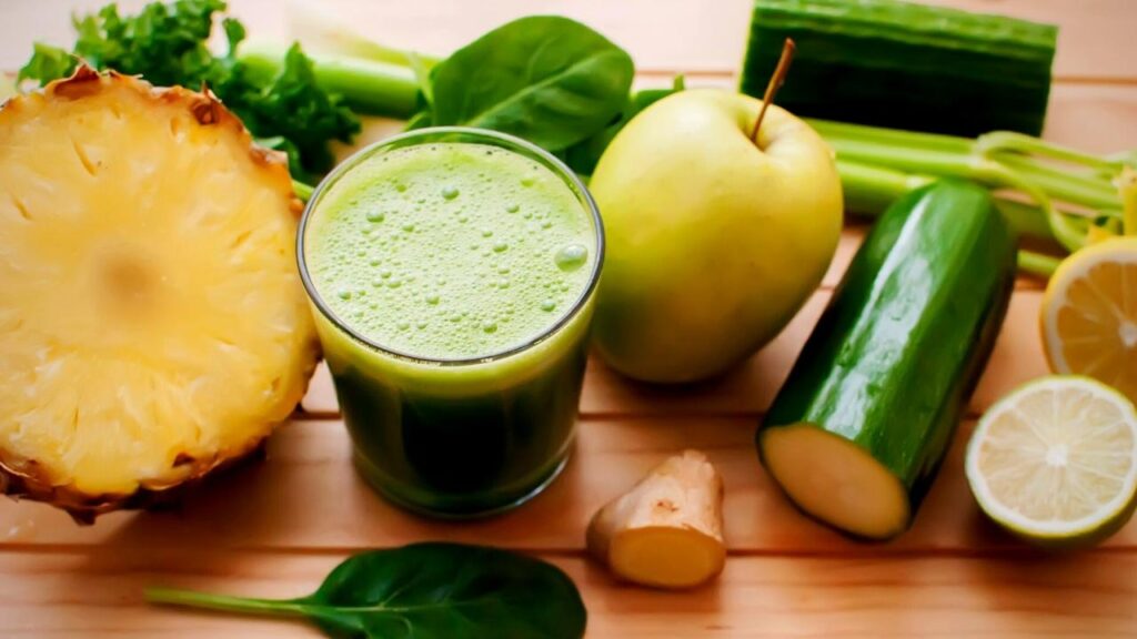 glass of green juice and ingredients