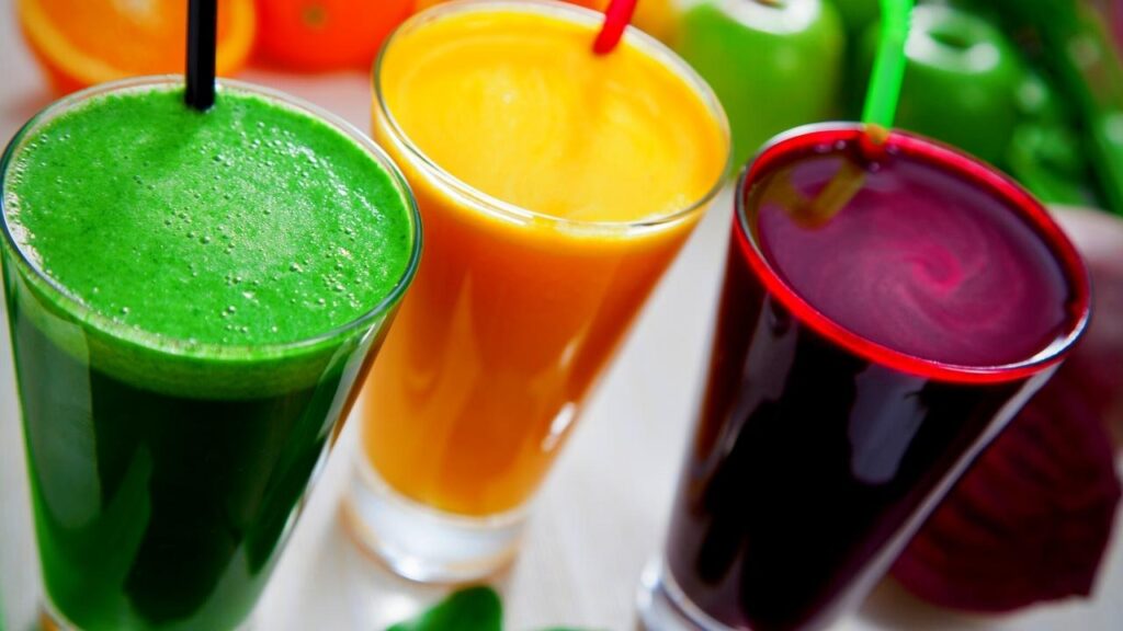 glasses of green, orange and beetroot juice