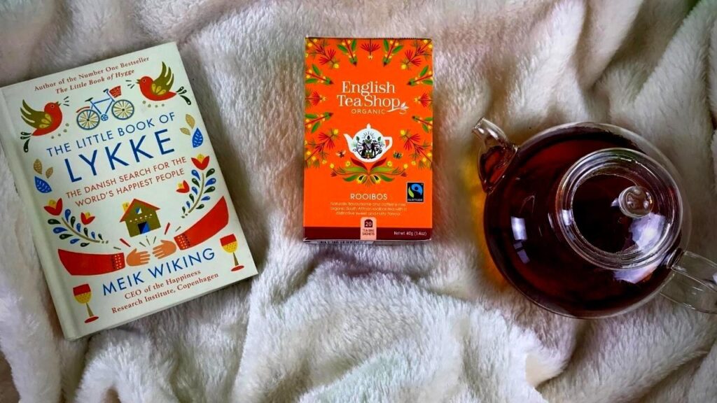 box of red bush tea, book and teapot