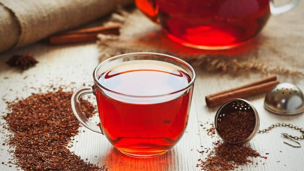 glass cup of rooibos tea beside tea leave