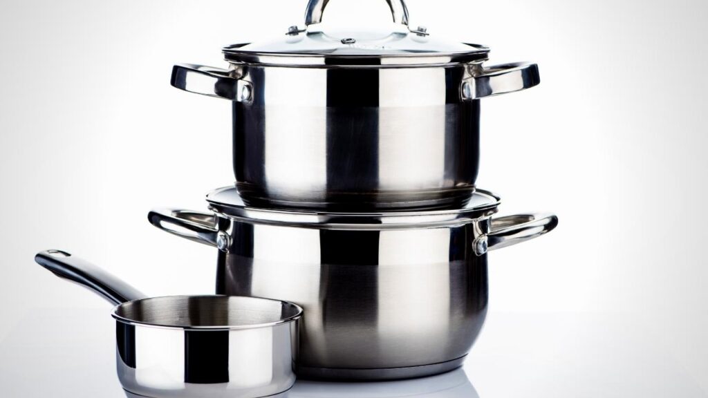 2 stainless steel pans stacked beside milk pan