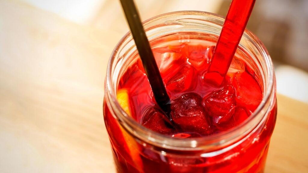 iced rooibos tea in a glass with a spoon