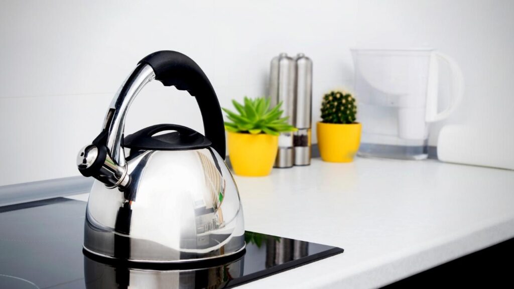 shiny stainless steel kettle on induction hob