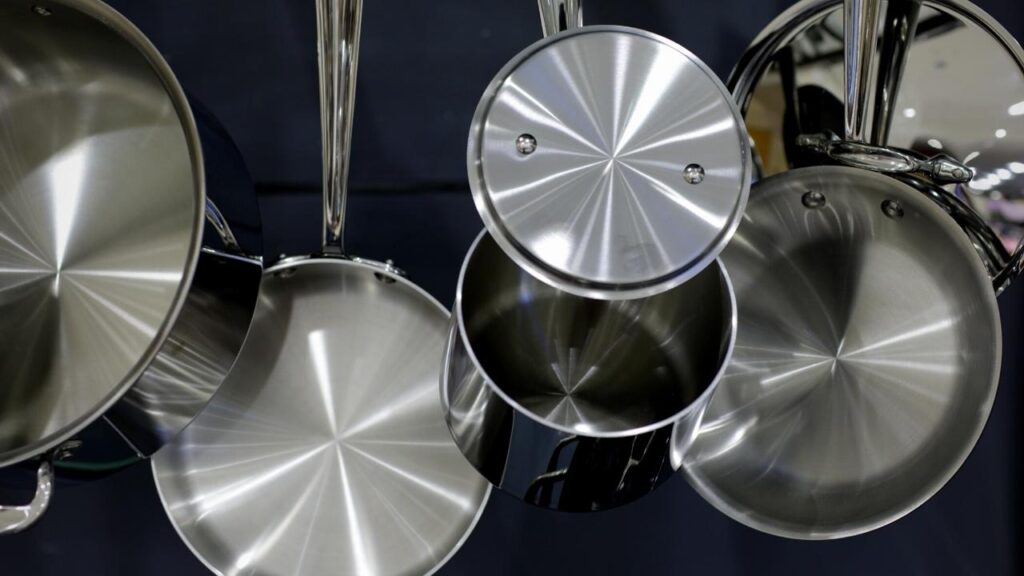 shiny stainless steel pans hanging up