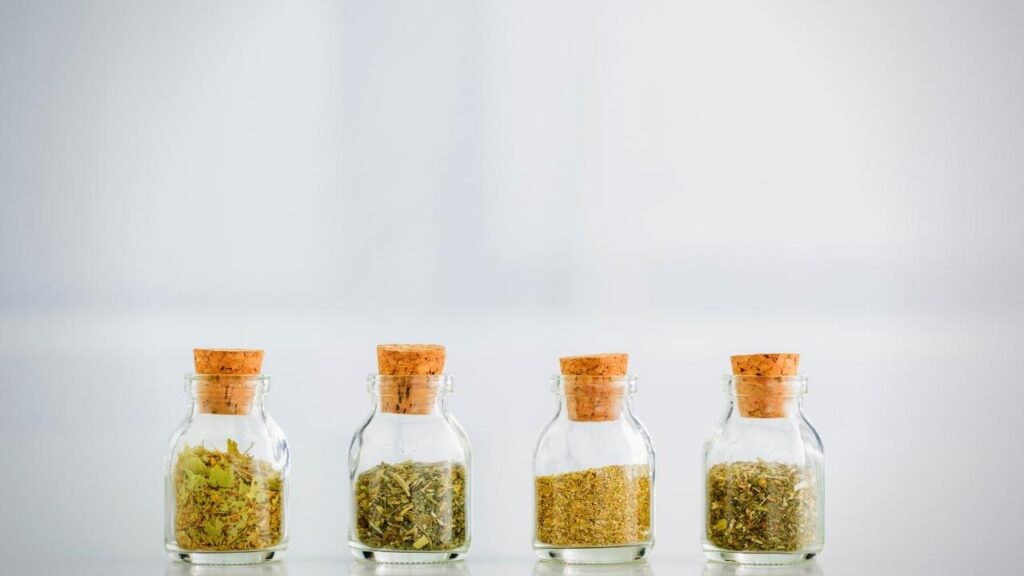 small glass bottles of dried herbs
