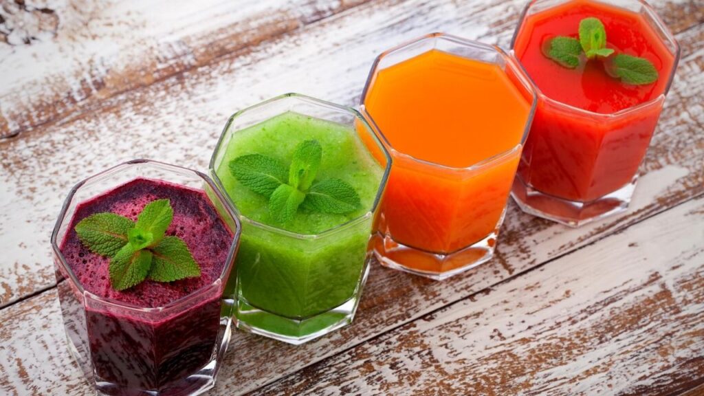 glasses of juice with herbs on top