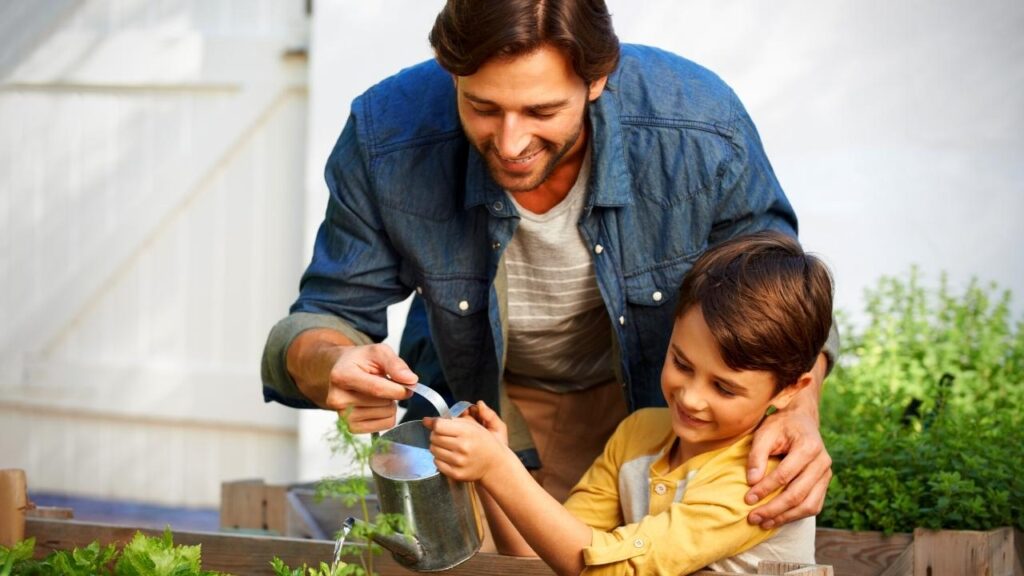 father and son tending to herbs